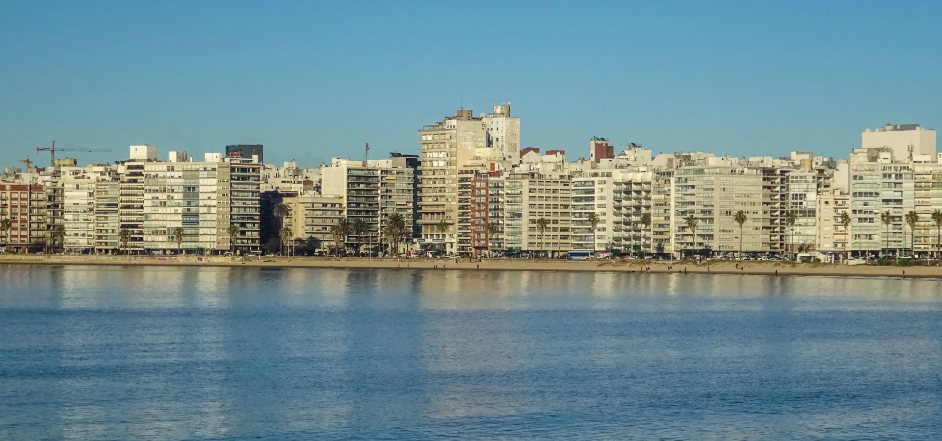 A serene view of montevideos skyline reflecting o — Seguro de viaje para Uruguay